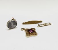 A high purity gold pendant set a pink stone, two 9ct gold brooches and a miniature pendant with 1902