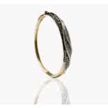 A contemporary 9ct gold hinged bangle wreathed with pave set white and pink diamonds 63x54 internal.