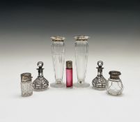 A pair of silver encased pear-shape perfume bottles, 9cm, three other silver-mounted bottles and a