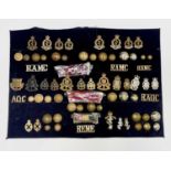 RAMC, RAOC, REME Corps Regiments. A display card containing cap badges, collar dogs, shoulder titles