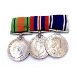 Police Medal Trio. Comprising: Long Service Medal (Queen Elizabeth) and Defence and War Medals