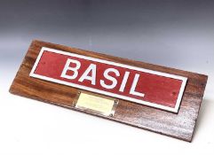 Railwayana - Nameplate "Basil". A mounted nameplate "Basil" (length 22" x 5") together with