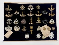 World War I Volunteer Battalions. A display card containing cap badges, collar dogs and buttons.