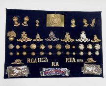 Royal Artillery. A display card containing cap badges, collar dogs, shoulder titles and buttons.