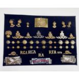 Royal Artillery. A display card containing cap badges, collar dogs, shoulder titles and buttons.