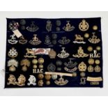 London Regiments - 1, Artists Rifles, etc. A display card containing cap badges, collar dogs,