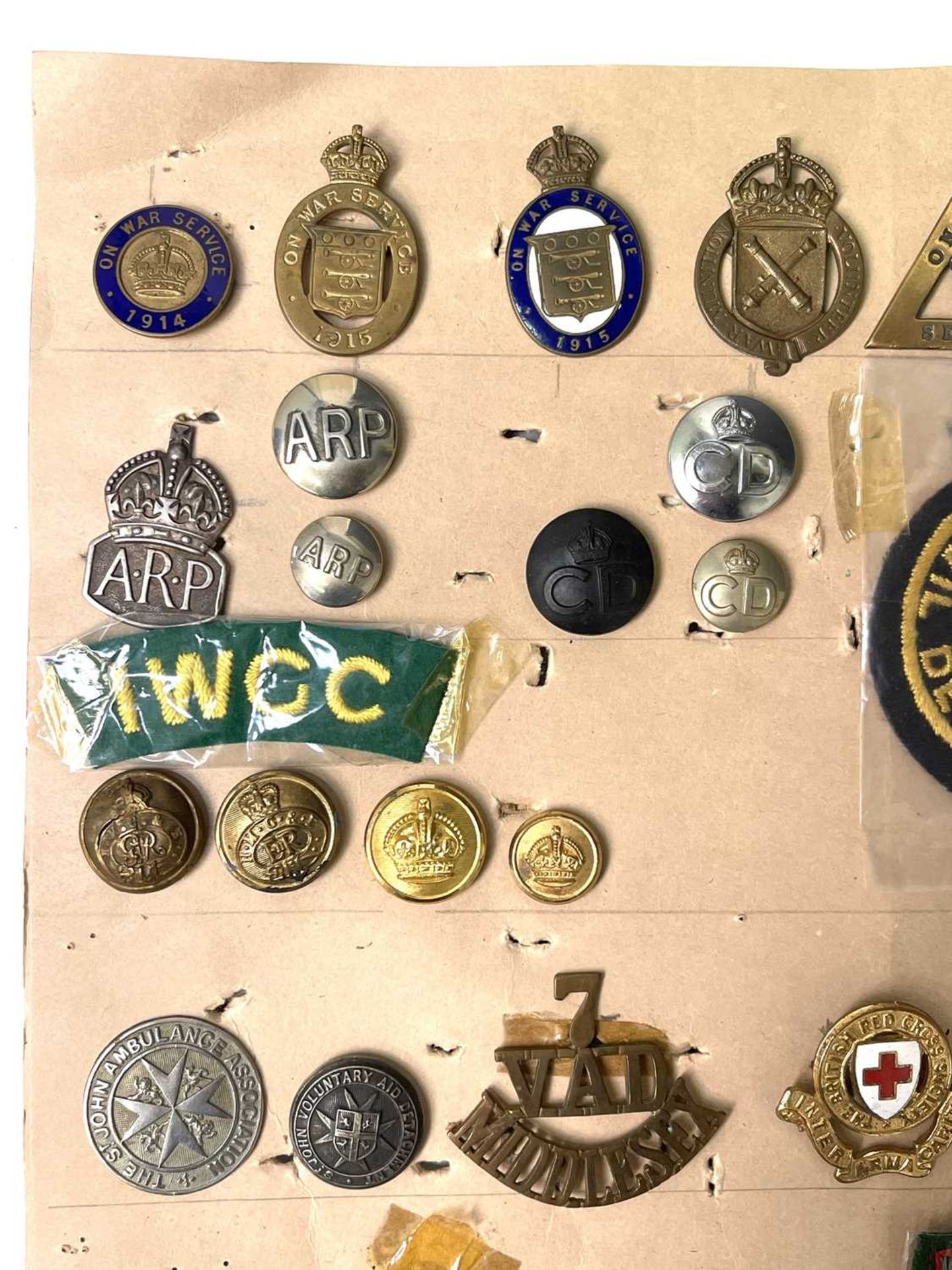 Military Auxiliary Services. A display card of badges, buttons, etc. Noted: On War Service, On War - Image 2 of 5