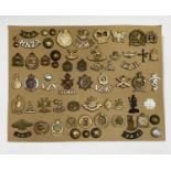 New Zealand Regiments. A display card containing cap badges, collar dogs, shoulder titles and