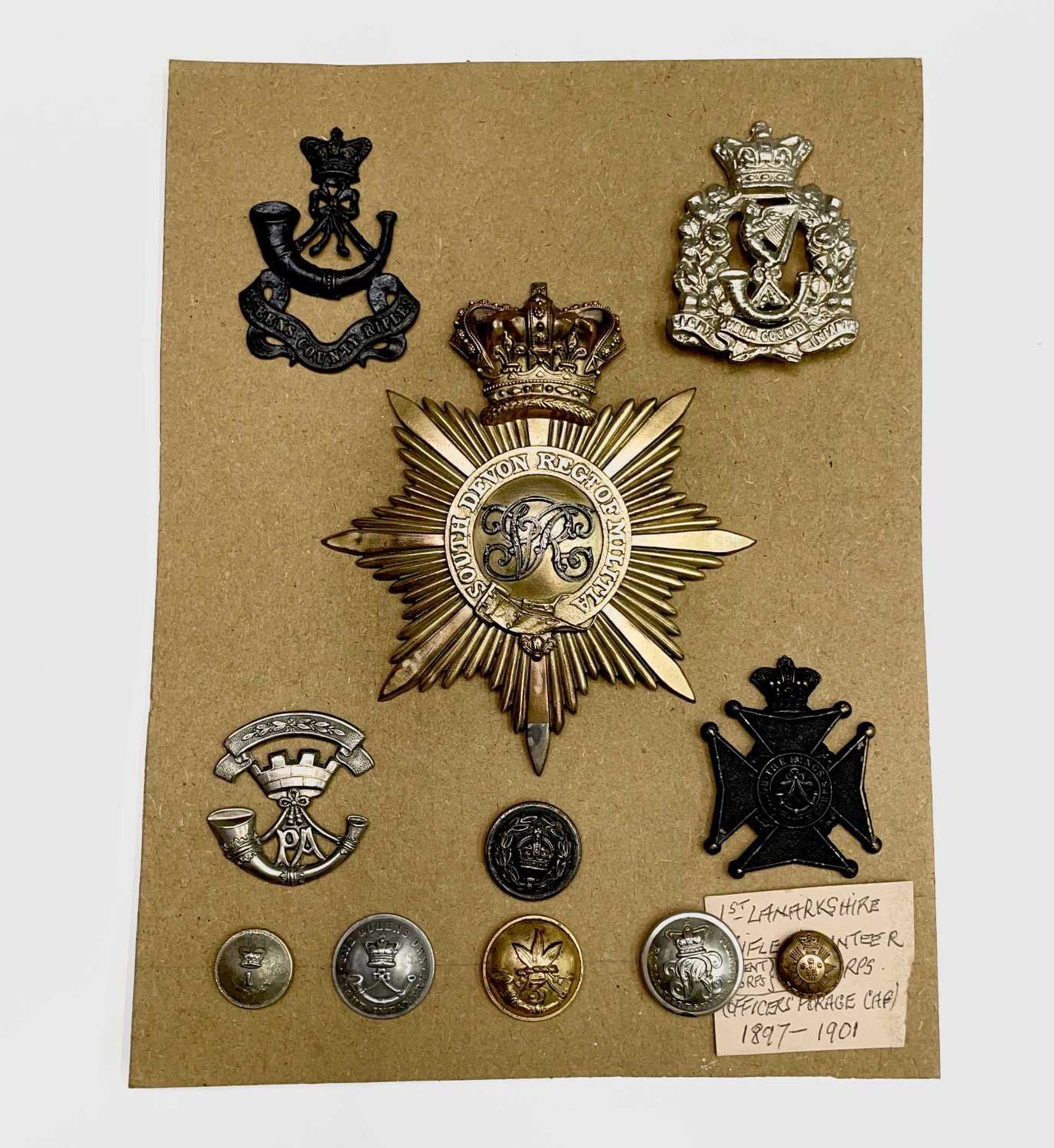 Shako Plate, Cap Badges and Buttons. A mainly 19th century card including South Devon Regiment of