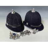 Police Helmet x 2. Plus Devon and Cornwall plastic helmet plates x 2, Devon and Cornwall cap