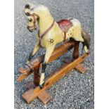 Child's wooden rocking horse. An early 20th century wooden horse with leather attachments - length