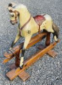 Child's wooden rocking horse. An early 20th century wooden horse with leather attachments - length