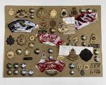 Australian Regiments. A display card containing cap badges, collar dogs, shoulder titles and