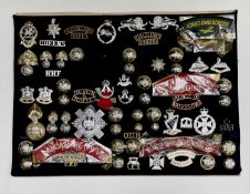 1960's Amalgamated Regiments. A display card containing cap badges, collar dogs, shoulder titles and