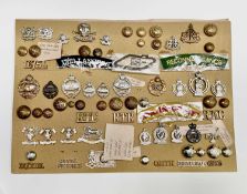 Lancers, Queens Dragoon Guards, etc. A display card containing cap badges, collar dogs, shoulder