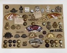 Australian Regiments. A display card containing cap badges, collar dogs, shoulder titles and