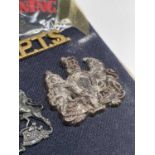 Corps - 1 & WRAC. A display card containing cap badges, collar dogs, shoulder titles and buttons.