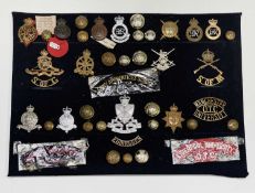 Army School Regiments and University Units. A display card containing cap badges, shoulder titles