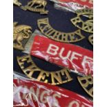 Infantry 1st - 5th Foot. A display card containing cap badges, collar dogs, shoulder titles and