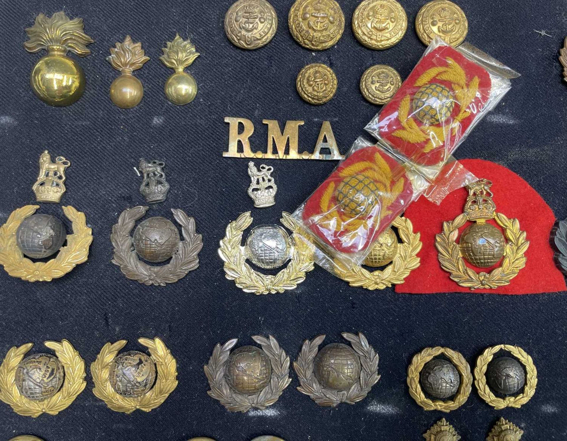 Royal Marines - 1. A cloth display of cap badges, collar dogs, shoulder titles and buttons. A - Image 2 of 4