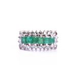 A diamond and emerald ring, set with six mixed-cut emeralds within a border of round brilliant-cut