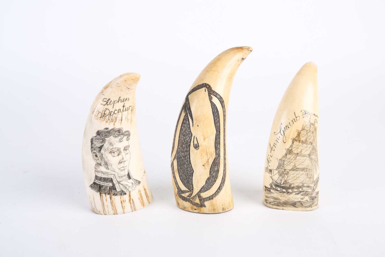 Three whale tooth scrimshaws, all with later decoration, depicting a whale, inscribed verso 1861, an