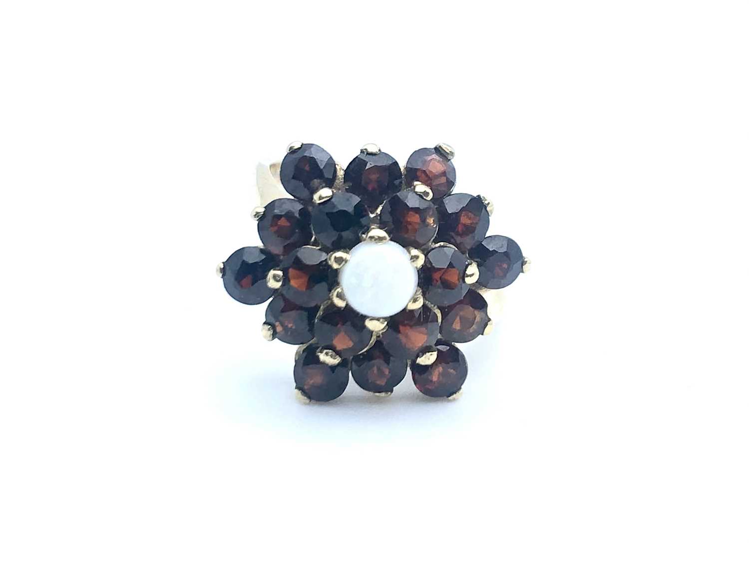 A 9ct yellow gold, garnet, and opal floral cluster ring, size K 1/2, 4.1 grams.