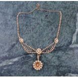 A late 19th / early 20th century yellow gold and pearl floral cluster drop necklace, set with seed