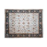 A large ivory ground Zeigler style Eastern carpet with large flower heads and scrolling foliage