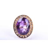 A mid 20th century 18ct yellow gold, diamond, and amethyst cocktail ring, set with a mixed oval-