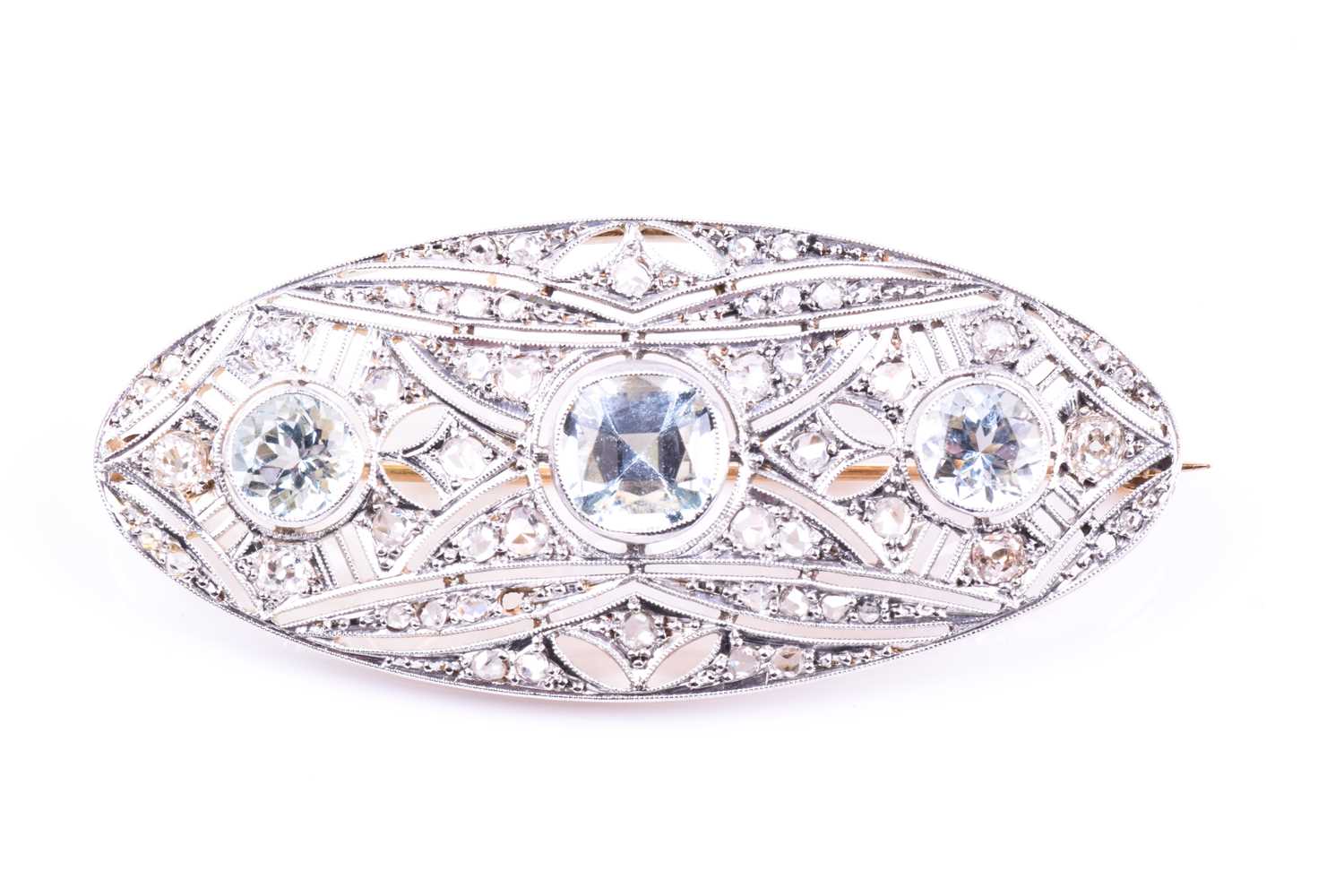 An Art Deco diamond and aquamarine brooch of elongated oval form, the openwork mount set with rose-