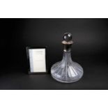 A late 20th century glass decanter with silver collar, 26 cm high, together with a boxed Carrs