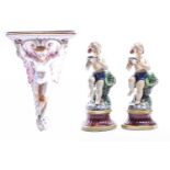 An Italian tin glazed wall bracket, 19th century, modelled as a faun flanked by leafy scrolls