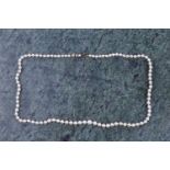 A cultured pearl necklace, set with graduated pearls measuring approximately 3 - 5 mm, fastened with
