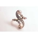 A diamond and pearl scroll ring, set with a silver pearl and a gold pearl, and small old-cut