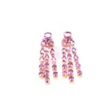 A pair of pink tourmaline drop earrings, each set with mixed round- and oval-cut pink tourmalines,