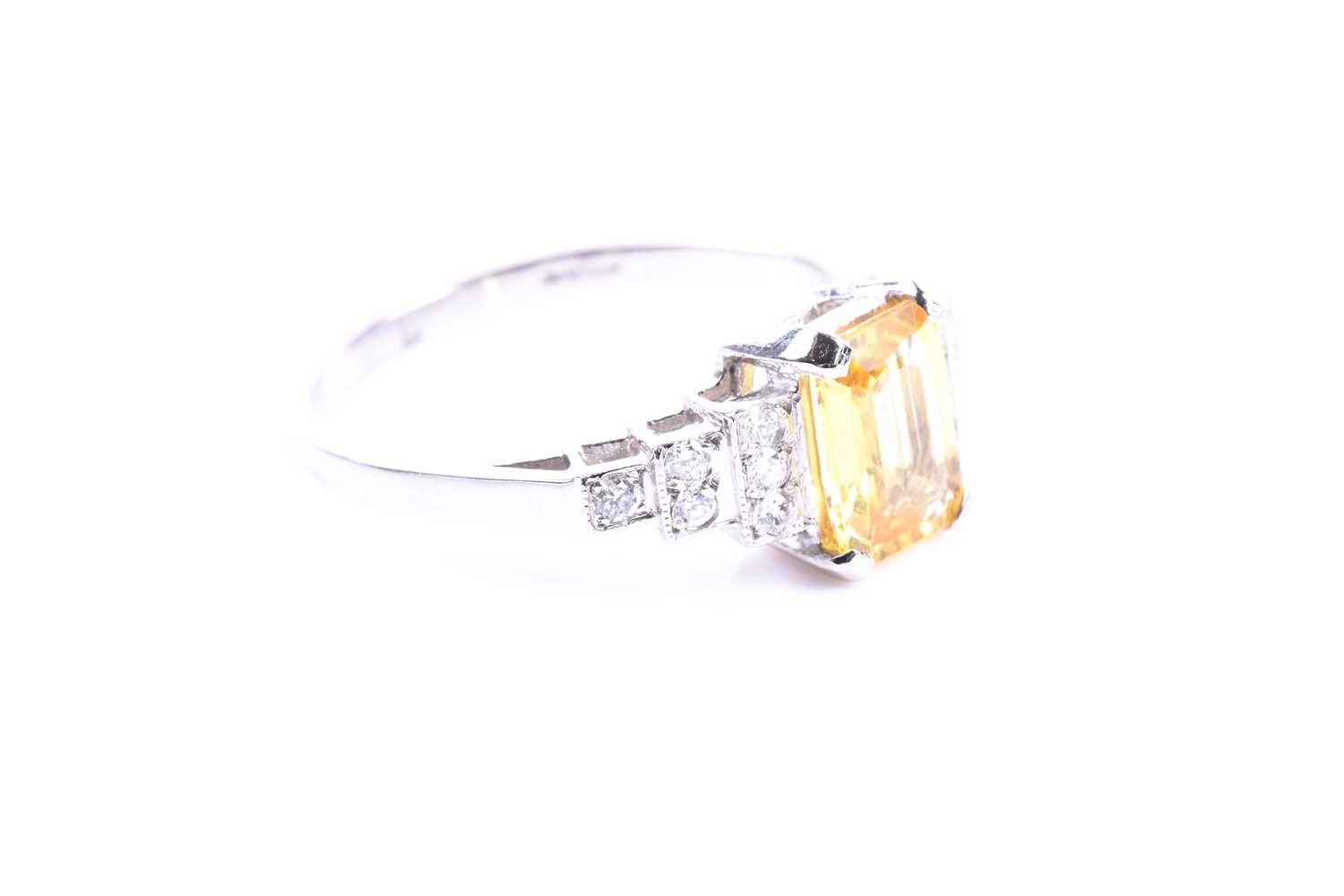 A platinum, diamond, and yellow sapphire ring set with a mixed emerald-cut yellow sapphire of - Image 2 of 4