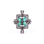 An unusual silver, diamond, and emerald cocktail ring, set with four pear-cut emeralds in a