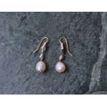 A pair of diamond and natural pearl drop earrings, each with two diamond-shaped mounts inset with