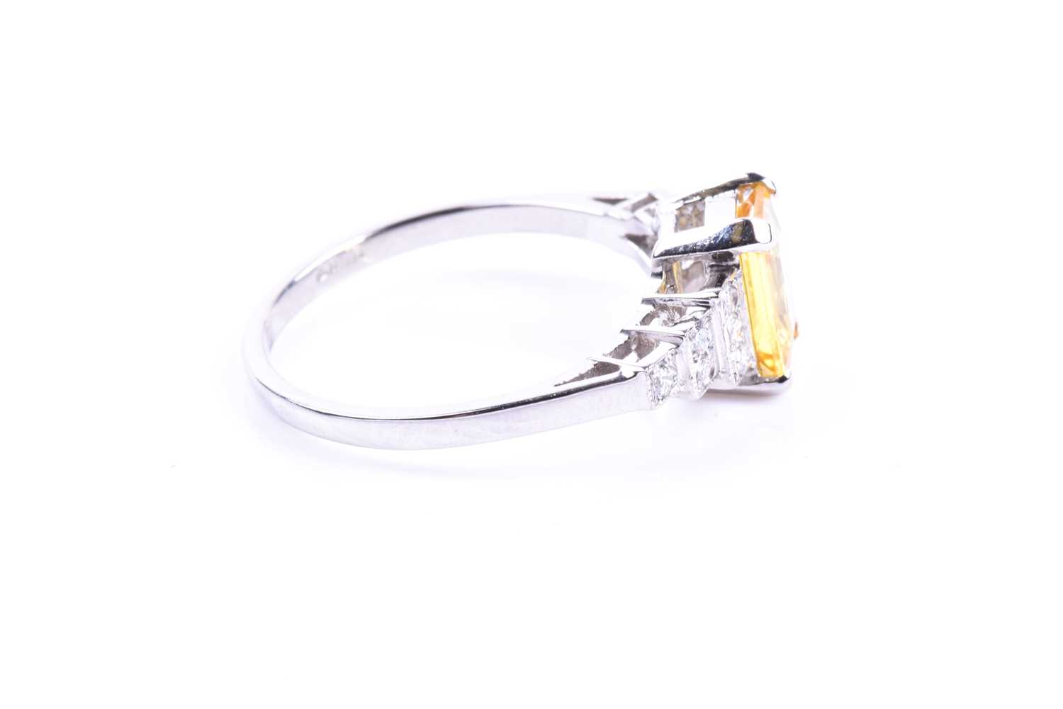 A platinum, diamond, and yellow sapphire ring set with a mixed emerald-cut yellow sapphire of - Image 3 of 4