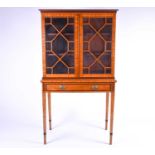 A Georgian style satinwood display cabinet on stand, 20th century, the glazed doors with ebony