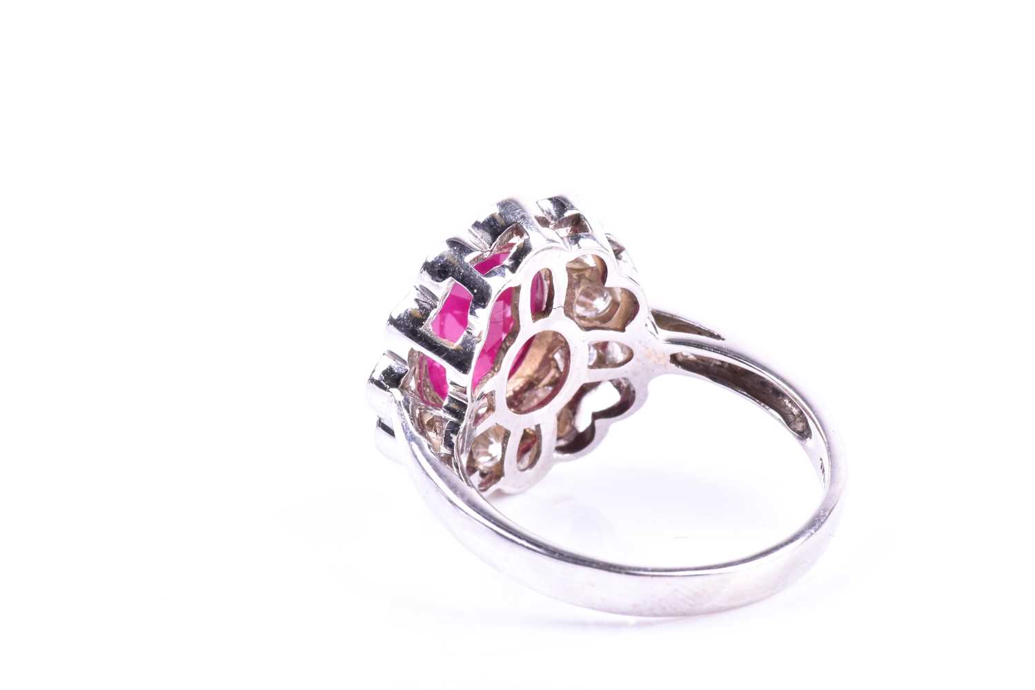 An 18ct white gold, diamond, and ruby cluster ring, set with a mixed oval-cut ruby of - Image 3 of 4