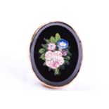 A yellow metal and micro mosaic ring, the black onyx mount inlaid with a floral design, shank
