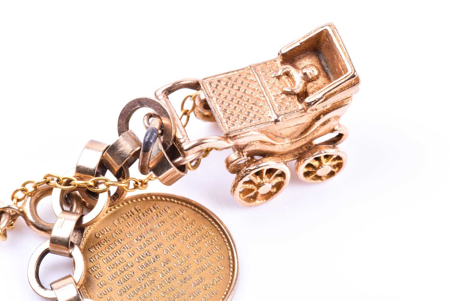 A 9ct yellow gold charm bracelet, suspended with various charms including a pram, a Paris charm, a - Image 3 of 5
