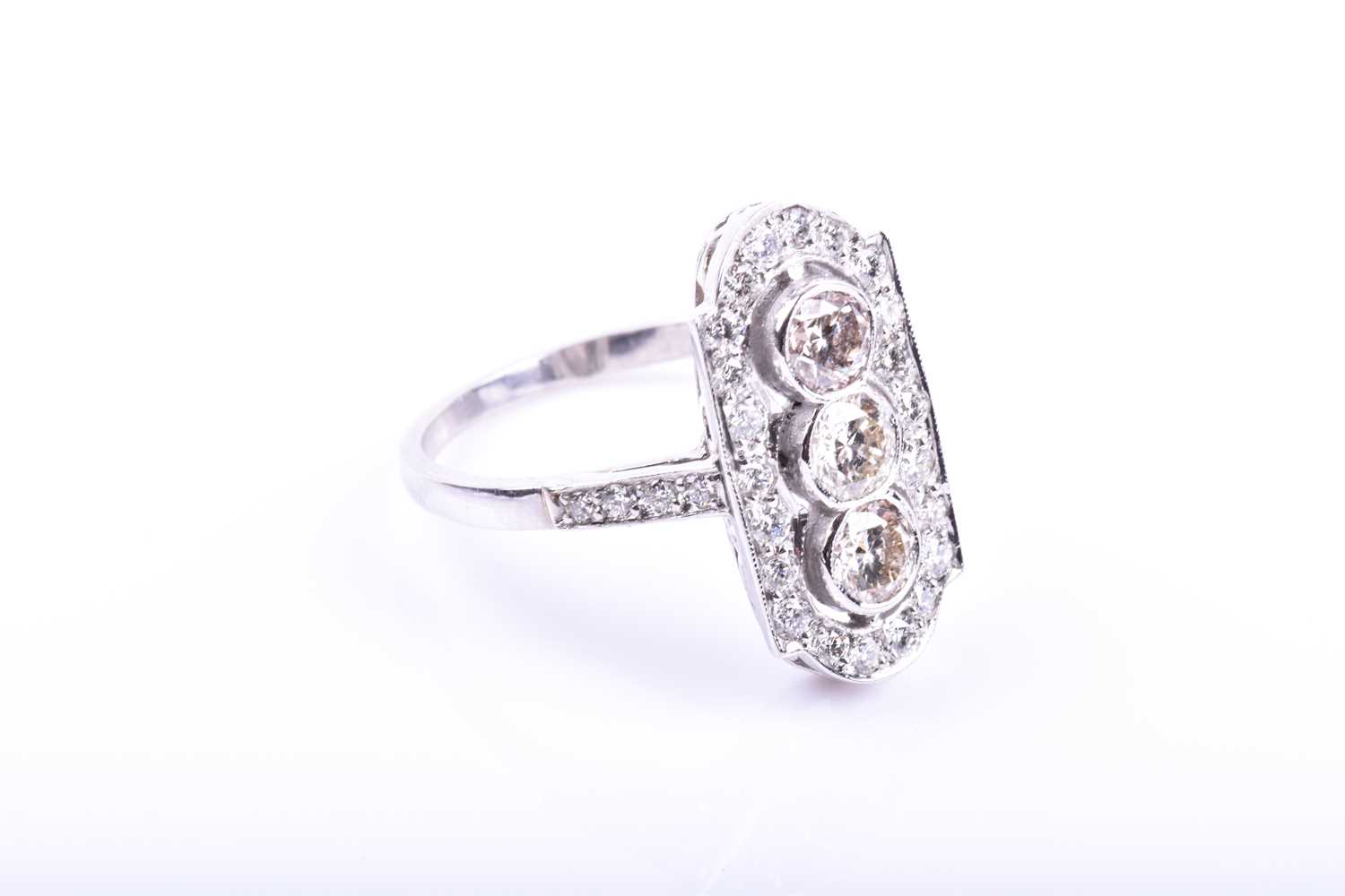 A platinum and diamond ring, in the Art Deco style, the lozenge-shaped plaque ring inset with - Image 4 of 5