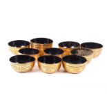 A collection of Chinese black lacquered bowls, with extensive gilt decoration and animals to the