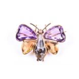 An amethyst and citrine butterfly brooch, the yellow metal mount set with mixed-cut gemstone