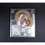 A 20th century Russian icon, Mother & Child, with white metal overlay, finished with relief Cryillic