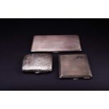 A group of three silver cigarette cases, various dates and makers, the largest 15.7 cm x 9 cm, 13