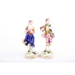 A pair of late 18th century Derby porcelain figurines, he carrying a plant and she with apples,